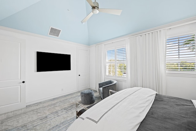 bedroom with high vaulted ceiling, visible vents, and a ceiling fan