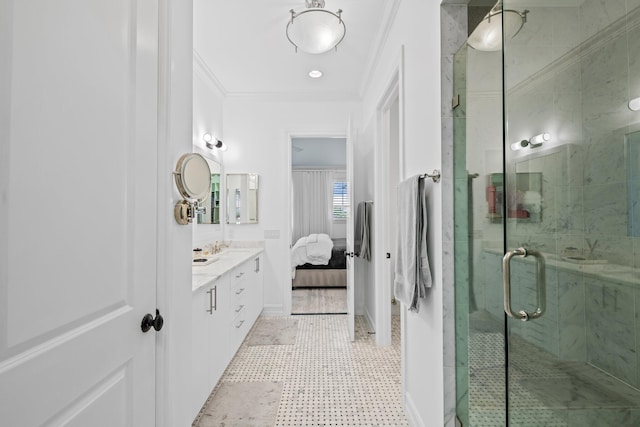 ensuite bathroom with connected bathroom, vanity, baseboards, a shower stall, and crown molding