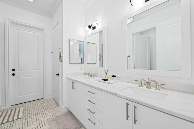 bathroom featuring double vanity, ornamental molding, and a sink