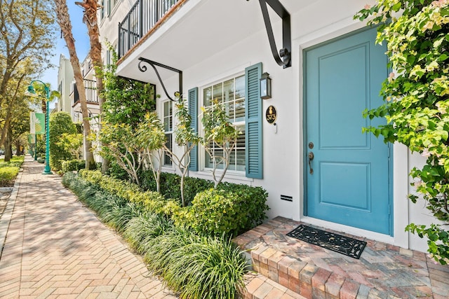 doorway to property with stucco siding