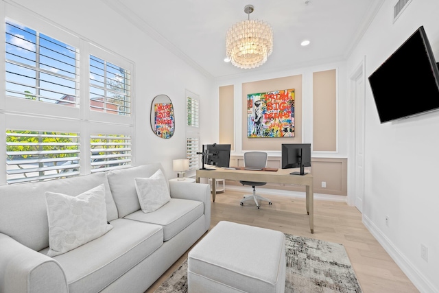 office area with light wood finished floors, visible vents, baseboards, crown molding, and a chandelier