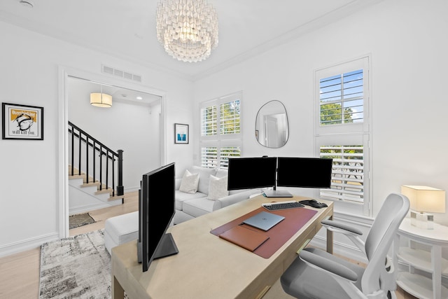 home office with baseboards, visible vents, ornamental molding, wood finished floors, and a notable chandelier