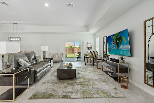 living room with visible vents, baseboards, and an inviting chandelier