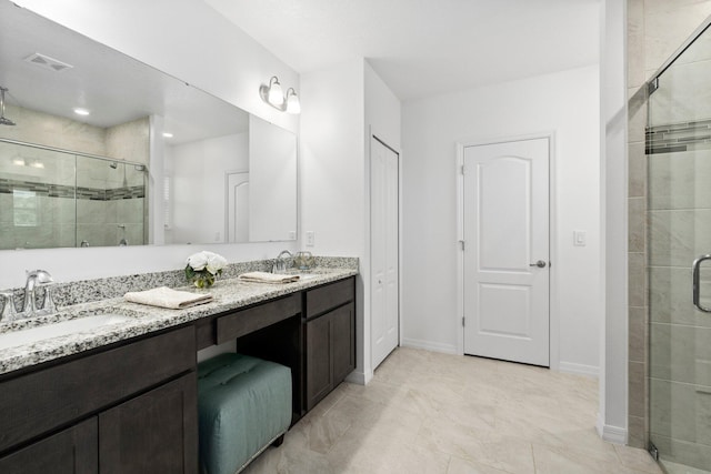 full bathroom featuring a sink, visible vents, baseboards, a shower stall, and double vanity