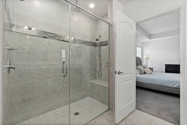 bathroom with a stall shower and connected bathroom