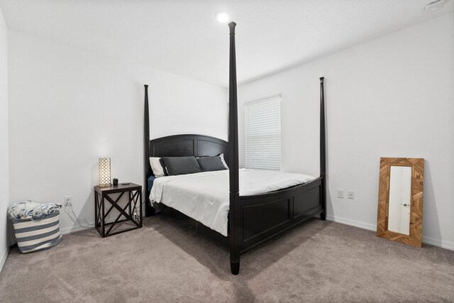 bedroom featuring carpet floors and baseboards