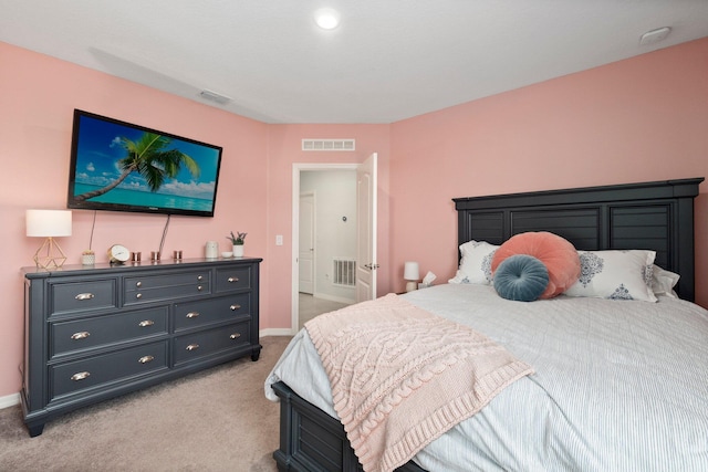 bedroom with visible vents, light carpet, and baseboards