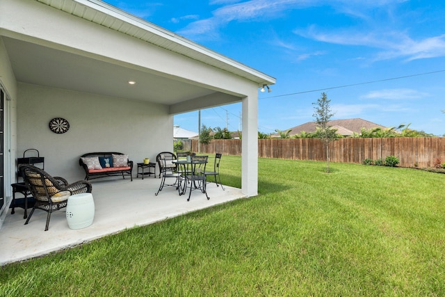 view of yard with fence and a patio