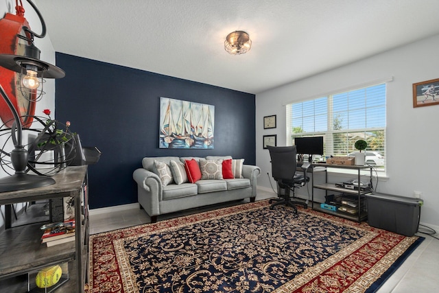 living area with tile patterned flooring and baseboards