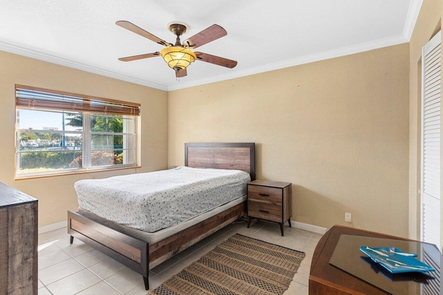 bedroom with light tile patterned floors, baseboards, and crown molding