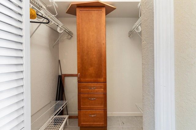 spacious closet with light tile patterned floors