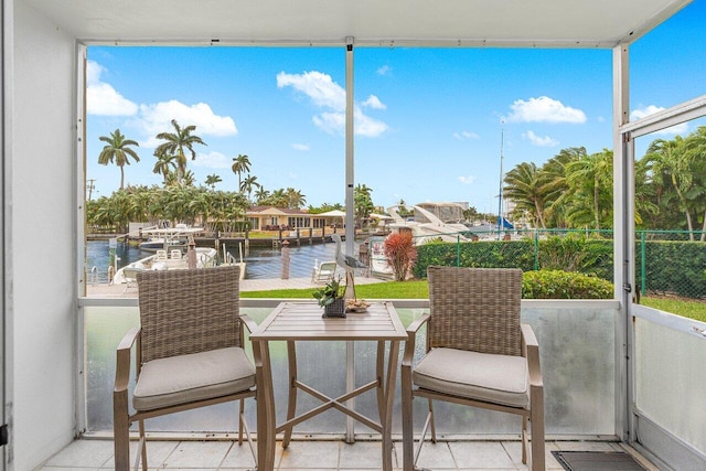 sunroom / solarium with a water view