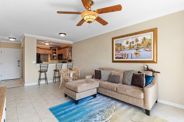 living area with crown molding, light tile patterned flooring, a ceiling fan, and baseboards