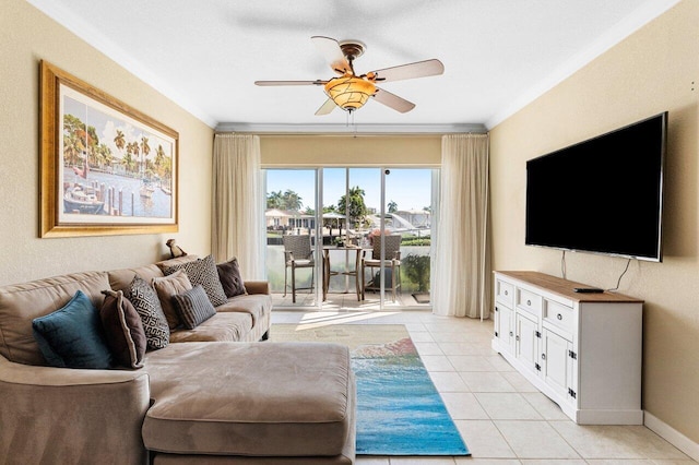 living area featuring light tile patterned floors, baseboards, crown molding, and a ceiling fan