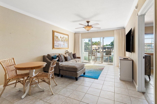 living area featuring a wealth of natural light, light tile patterned floors, a ceiling fan, and ornamental molding