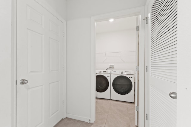 washroom featuring laundry area, light tile patterned flooring, and washing machine and dryer