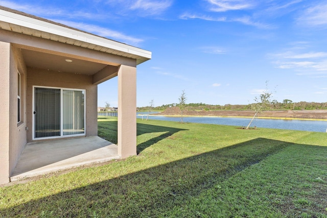 view of yard featuring a water view and a patio area