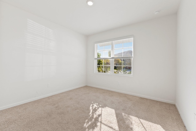 unfurnished room featuring baseboards and carpet flooring