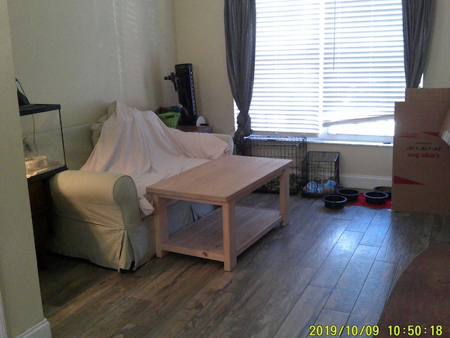 bedroom featuring wood finished floors and baseboards