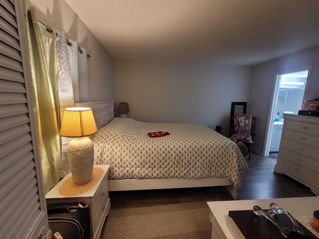 bedroom featuring wood finished floors and a textured ceiling