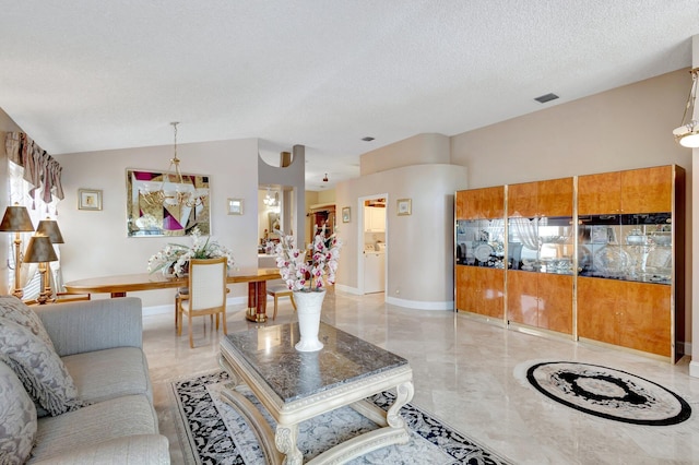 living room with lofted ceiling, visible vents, a textured ceiling, and baseboards