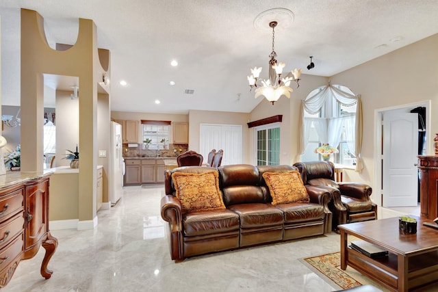 living room featuring a notable chandelier, lofted ceiling, visible vents, a textured ceiling, and baseboards