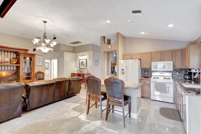 kitchen featuring lofted ceiling, white appliances, a kitchen breakfast bar, open floor plan, and tasteful backsplash