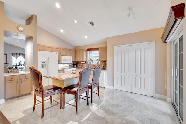 dining space with lofted ceiling, baseboards, visible vents, and recessed lighting