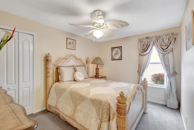 bedroom with baseboards, ceiling fan, a textured ceiling, and light colored carpet