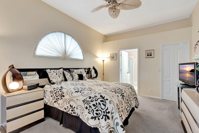 bedroom with light carpet, baseboards, and a ceiling fan