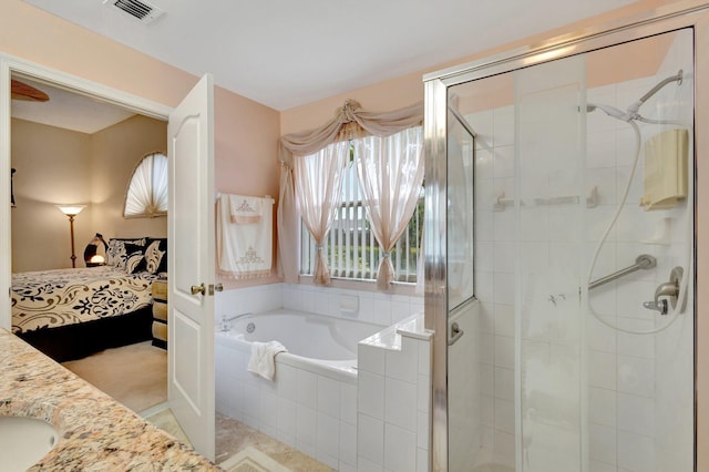 ensuite bathroom featuring a garden tub, visible vents, connected bathroom, and a stall shower