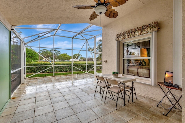 unfurnished sunroom with a ceiling fan