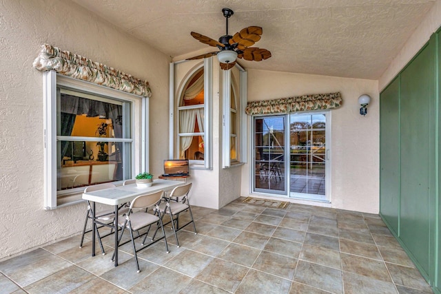 view of patio featuring outdoor dining area and a ceiling fan