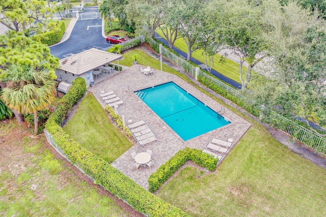 pool featuring fence, a lawn, and a patio