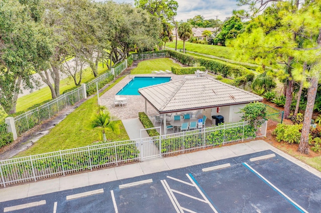 view of swimming pool featuring a fenced in pool, a lawn, fence private yard, a grill, and a patio area