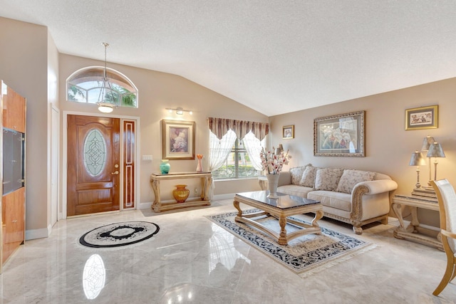 living room featuring a textured ceiling, vaulted ceiling, and baseboards