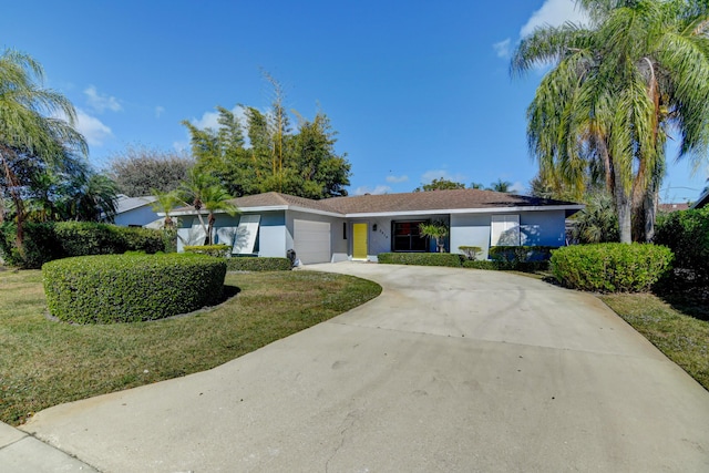 ranch-style house featuring a garage, a front lawn, concrete driveway, and stucco siding