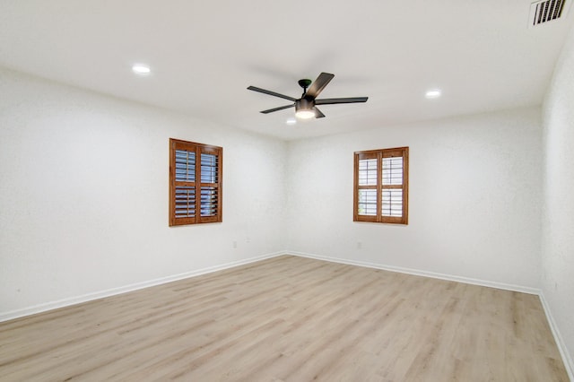 spare room with recessed lighting, visible vents, light wood-style flooring, a ceiling fan, and baseboards