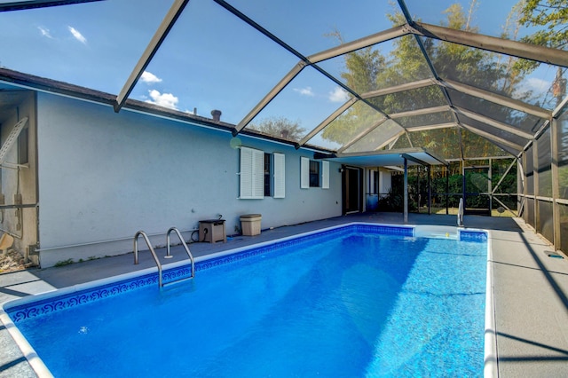 outdoor pool featuring glass enclosure and a patio