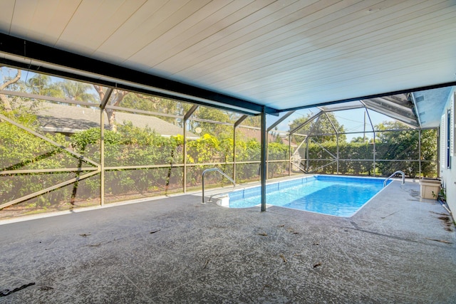 outdoor pool with a patio and a lanai