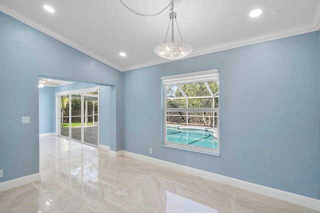 spare room with a healthy amount of sunlight, crown molding, and baseboards