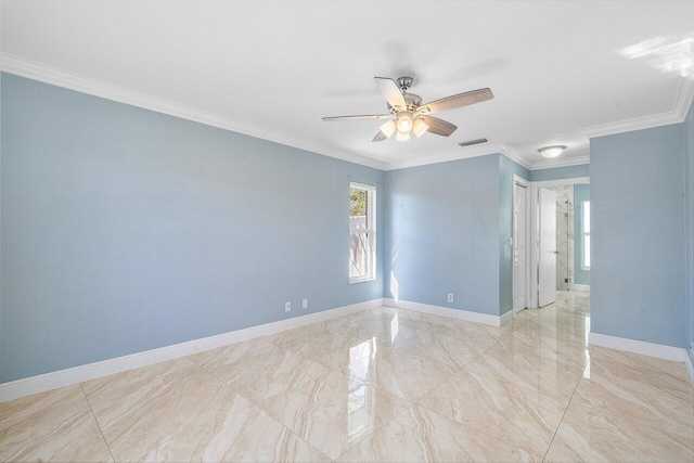 empty room featuring a ceiling fan, visible vents, crown molding, and baseboards