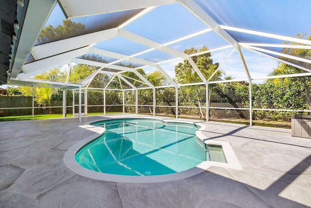 view of swimming pool with a lanai, a patio area, fence, and a fenced in pool