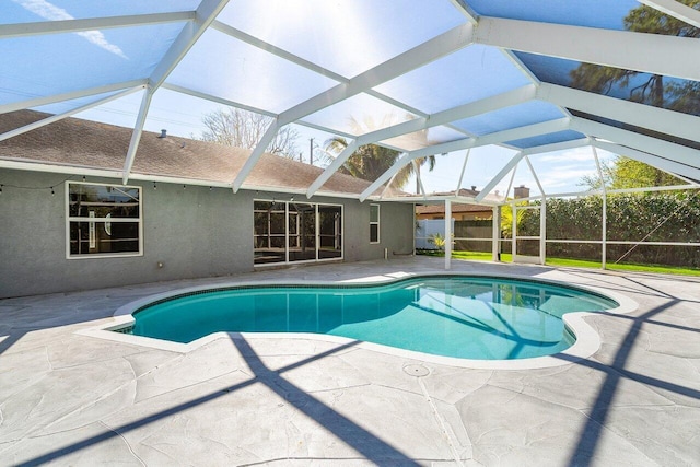 pool featuring a patio area and glass enclosure