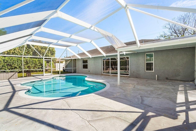 outdoor pool featuring a patio area and a lanai