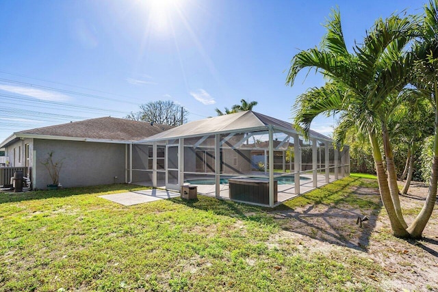 back of house with a lanai, a yard, stucco siding, an outdoor pool, and a patio area