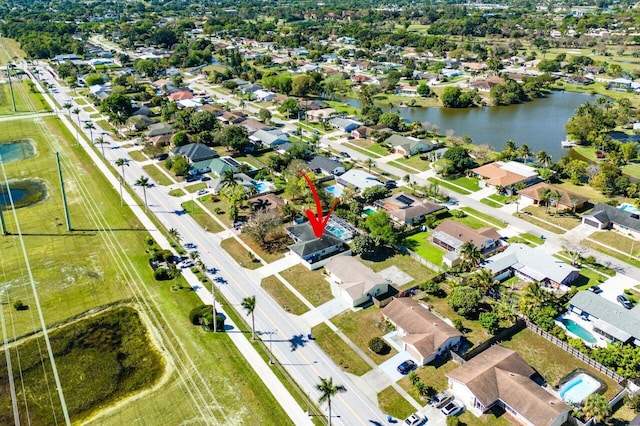 drone / aerial view with a residential view and a water view