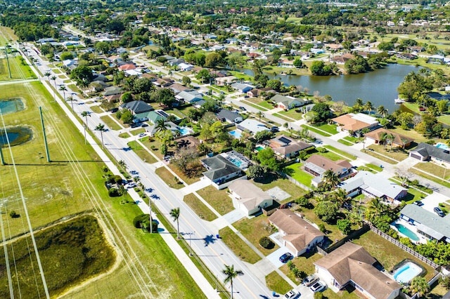 drone / aerial view featuring a residential view and a water view