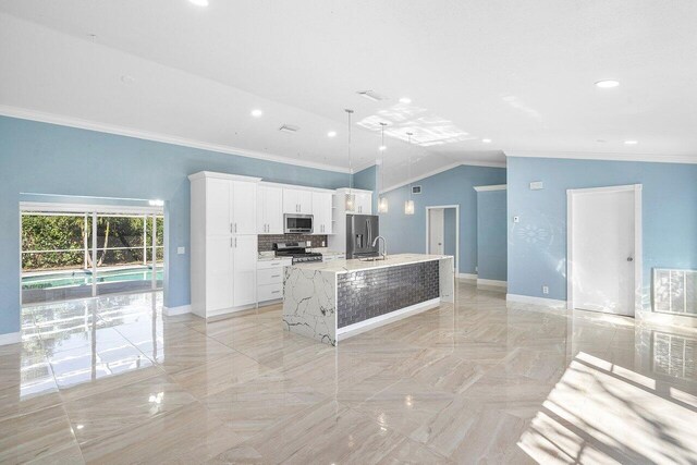 kitchen with an island with sink, stainless steel appliances, crown molding, white cabinetry, and a sink