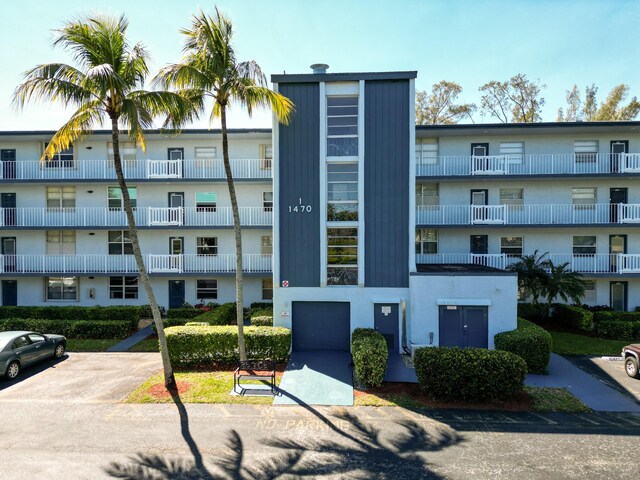 view of building exterior with uncovered parking